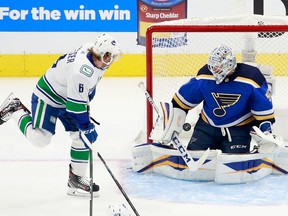 Jordan Binnington of the St. Louis Blues stops a first period shot from Bo Horvat #53 of the Vancouver Canucks (not shown) as Brock Boeser looks for the rebound in Game Two of the Western Conference First Round during the 2020 NHL Stanley Cup Playoffs at Rogers Place on August 14, 2020 in Edmonton