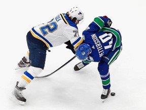 Justin Faulk ties up Elias Pettersson on Monday night in Edmonton.