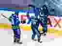 Defenceman Troy Stecher greets teammates Brandon Sutter and Elias Pettersson after scoring in the second period of Game 6 of their NHL Western Conference first-round playoff series against the St. Louis Blues at Rogers Place in Edmonton on Aug. 21, 2020.