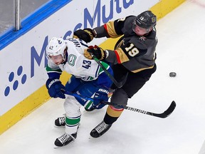 The elusive Quinn Hughes, here taking a cross-check to the back from Vegas Golden Knight Reilly Smith in the playoff bubble last summer, is always a target for hounding and pounding from the opposition.