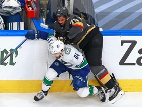 Ryan Reaves of the Vegas Golden Knights hits Tyler Motte of the Vancouver Canucks during the second period in Game One of the Western Conference Second Round during the 2020 NHL Stanley Cup Playoffs at Rogers Place on Sunday in Edmonton.