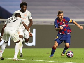 Bayern Munich fullback and Canadian international Alphonso Davies (second from left) chases down Barcelona’s Lionel Messi during their UEFA Champions League quarter-final match on Aug. 14, 2020 in Lisbon, Portugal. Bayern thrashed Barcelona 8-2.