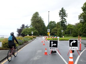 A cyclist enters Stanley Park along Beach Avenue.