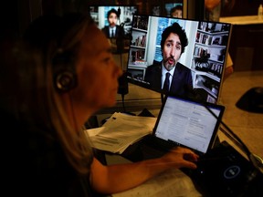 Prime Minister Justin Trudeau is seen on screens as he attends a virtual House of Commons finance committee meeting in Ottawa on July 30.