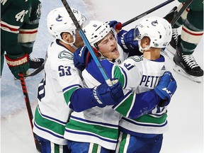 Brock Boeser celebrates his goal Thursday with teammates Elias Pettersson and Bo Horvat.