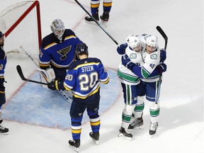 Vancouver Canucks Elias Pettersson and Bo Horvat, right, celebrate a third-period goal against the St. Louis Blues in Friday's Game 2 of their Stanley Cup playoff series at Rogers Place in Edmonton.