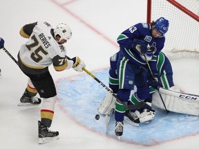 Vegas Golden Knights right wing Ryan Reaves shoots on goal against Vancouver Canucks defenseman Quinn Hughes and goaltender Jacob Markstrom during the first period in game three of the second round of the 2020 Stanley Cup Playoffs at Rogers Place.