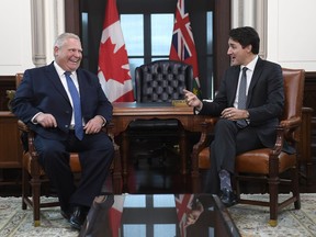 Prime Minister Justin Trudeau and the Premier of Ontario Doug Ford share a laugh after Ford spoke in French during a meeting in Ottawa, Nov. 22, 2019.