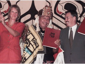 Joseph Arthur Gosnell – an admired leader of the Nisga'a Nation and an Order of B.C. recipient – has died of cancer. Gosnell is pictured (middle) in this file photo, holding up the Nisga'a Final Agreement that they have just initialled. He is pictured alongside Jane Stewart, then Minister for Northern Development (left) and Glen Clark, then premier of B.C. (right).