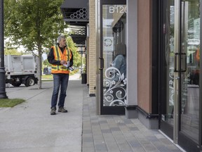 A WorkSafeBC prevention officer maintains physical distance while inspecting a business in Surrey.