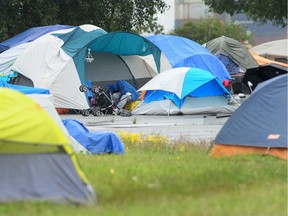 Homeless people in their tents in the CRAB Park parking lot, near Burrard Inlet.