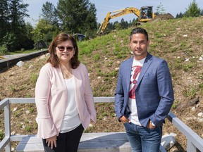 Chief Leah George-Wilson of the Tsleil-Waututh Nation and Dennis Thomas-Whonoak, the Nation's business development manager, pose in front of the site where solar panels will be installed as part of the Nation's energy project in North Vancouver on Aug. 11.