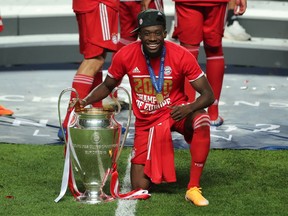 Soccer Football - Champions League - Final - Bayern Munich v Paris St Germain - Estadio da Luz, Lisbon, Portugal - August 23, 2020 Bayern Munich's Alphonso Davies poses as he celebrates winning the Champions League with the trophy, as play resumes behind closed doors following the outbreak of the coronavirus disease (COVID-19)