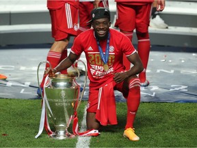 Bayern Munich's Alphonso Davies poses as he celebrates winning the Champions League with the trophy on Sunday, Aug. 23, 2020.