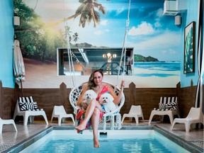 Doggieville MTL owner Tatiana Custode inaugurates the indoor pool with Ruby and Chloe.
