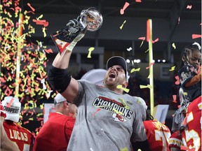 Laurent Duvernay-Tardif of the Kansas City Chiefs raises the Vince Lombardi Trophy after defeating the San Francisco 49ers 31-20 in Super Bowl LIV at Hard Rock Stadium on February 02, 2020 in Miami, Florida.