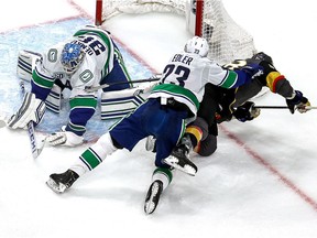 Thatcher Demko and Alex Edler team up to keep puck out of net Tuesday.