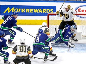 Shea Theodore of the Vegas Golden Knights gets in behind Thatcher Demko of the Vancouver Canucks in the second period.