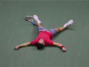 Dominic Thiem of Austria lays down in celebration after winning championship point after a tie-break during his Men's Singles final match against and Alexander Zverev of Germany on Day Fourteen of the 2020 US Open at the USTA Billie Jean King National Tennis Center on September 13, 2020 in the Queens borough of New York City.