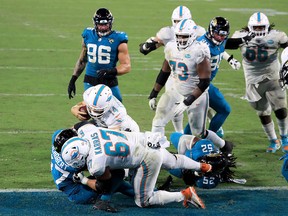 Dolphins QB Ryan Fitzpatrick lunges for a touchdown at the Jaguars' goal line on Thursday night at TIAA Bank Field in Jacksonville. Miami won 31-13.