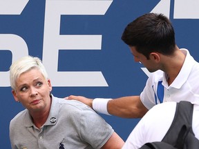 Novak Djokovic of Serbia tends to a line judge who was hit with the ball during his Men's Singles fourth round match against Pablo Carreno Busta of Spain on Day Seven of the 2020 US Open at the USTA Billie Jean King National Tennis Center on September 6, 2020 in the Queens borough of New York City.