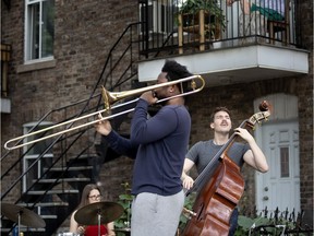 A group of friends play jazz music for the neighbours on Cazelais St. in Montreal in July 2020.