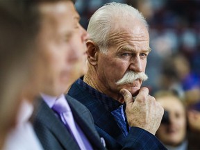 Dec 19, 2019; Calgary, Alberta, CAN; Lanny McDonald looks on from the Calgary Flames bench during the warmups prior to the Flames' game against the Montreal Canadiens at Scotiabank Saddledome.