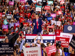 U.S. President Donald Trump, center, claps during a campaign rally at Xtreme Manufacturing's warehouse in Henderson, Nevada, U.S., on Sunday, Sept. 13, 2020.