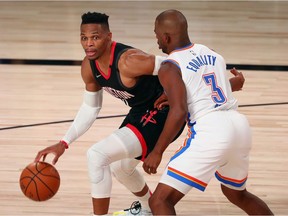 Houston Rockets guard Russell Westbrook (0) dribbles the ball against Oklahoma City Thunder guard Chris Paul (3) during the second half of game seven of the first round of the 2020 NBA Playoffs at ESPN Wide World of Sports Complex.
