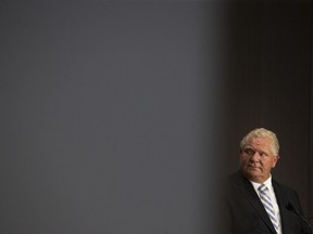 Ontario Premier Doug Ford stands at the lecturn during a joint press conference with Ontario Premier Doug Ford, at the Ontario-Quebec Summit in Toronto on Wednesday, September 9, 2020.