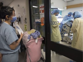 A nurse stands by with additional equipment outside a COVID-19-suspected patient's room in the COVID intensive care unit at St. Paul's Hospital in Downtown Vancouver on April 21.