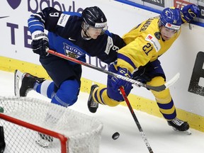 Finland defenceman Toni Utunen (left) leans on Sweden winger — and fellow Vancouver Canucks prospect — Nils Hoglander during the Finland-Sweden bronze medal game at the 2020 world juniors in Ostrava, Czech Republic, on Jan. 5, 2020.