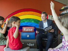 B.C. Education Minister Rob Fleming reads to children last year as part of the Raise-a-Reader program.