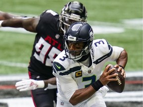 Seattle Seahawks quarterback Russell Wilson runs with the ball against the Atlanta Falcons during the first half at Mercedes-Benz Stadium.