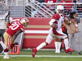 Quarterback Kyler Murray of the Arizona Cardinals carries the football en route to scoring on a 22 rushing touchdown ahead of cornerback Jimmie Ward #20 of the San Francisco 49ers during the second half of the NFL game at Levi's Stadium on November 17, 2019 in Santa Clara, Calif.