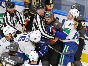 Vegas Golden Knights right wing Ryan Reaves (75) and Vancouver Canucks left wing Antoine Roussel (26) are separated during a scuffle during the second period in Game 5 on Tuesday night.