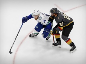 Tyler Motte of the Vancouver Canucks, left, battles for puck possession with Paul Stastny of the Vegas Golden Knights during the Stanley Cup playoffs at Rogers Place in Edmonton earlier this month.