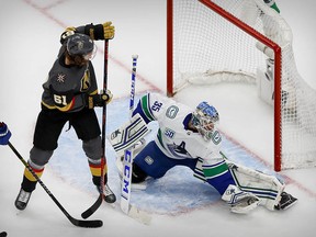 Canucks goalie Thatcher Demko stops a shot by Vegas Golden Knights right wing Mark Stone in the first period of the deciding Game 7.