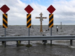 A cross honouring those killed by Hurricane Katrina stands in the Mississippi River-Gulf Outlet before the possible arrival of Hurricane Sally on September 14, 2020 in Shell Beach, Louisiana.