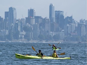 Kyakers takes to the waters off Jericho Beach on a sunny day Vancouver, BC.