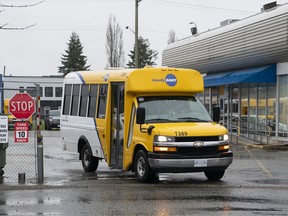 A HandyDART bus leaves the yard in Surrey, BC