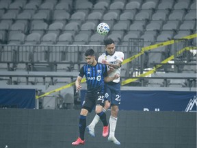 Vancouver Whitecaps defender Erik Godoy (22) heads the ball with Montreal Impact midfielder Emanuel Maciel (25) during the first half of MLS soccer action in Vancouver, B.C. Sunday, September, 13, 2020.