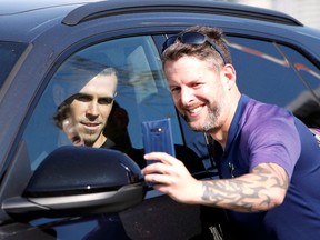 Gareth Bale (left) poses for a photo with a fan as he leaves London’s Luton Airport on Sept. 18, 2020.