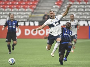 Vancouver Whitecaps midfielder David Milinkovic (7) controls the ball against against Montreal Impact defender Zachary Brault-Guillard (15) during the first half at BC Place.