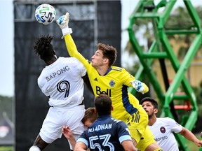 Vancouver Whitecaps goalkeeper Thomas Hasal punches the ball away from Chicago Fire forward C.J. Sapong at the ESPN Wide World of Sports Complex in the MLS is Back Tournament. Called into action because of a season-ending injury to starter Max Crepeau, Hasal established himself as a first-team quality player before being sidelined by injury himself.