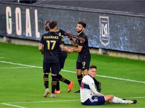Los Angeles FC forward Diego Rossi (9) celebrates with forward Bradley Wright-Phillips (66) and midfielder Brian Rodriguez (17) his goal scored against the Vancouver Whitecaps during the first half at Banc Of California Stadium.