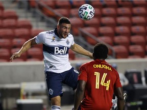 Sep 19, 2020; Sandy, Utah, USA;  Vancouver Whitecaps forward Lucas Cavallini (9) passes the ball against Real Salt Lake defender Nedum Onuoha (14) during the second half at Rio Tinto Stadium. Mandatory Credit: Jeffrey Swinger-USA TODAY Sports