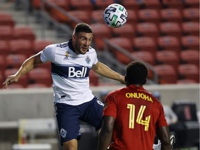 Vancouver Whitecaps forward Lucas Cavallini, top, passes the ball against Real Salt Lake defender Nedum Onuoha during the second half at Rio Tinto Stadium on Sept 19.