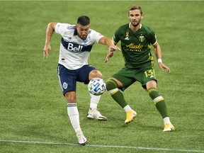 Vancouver Whitecaps forward Lucas Cavallini controls a pass during the first half against Portland Timbers defender Dario Zuparic at Providence Park on Sunday. Photo: Troy Wayrynen-USA TODAY Sports