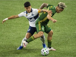 Vancouver Whitecaps forward Fredy Montero, left, defends Portland Timbers defender Pablo Bonilla during their Sept. 27 meeting at Providence Park. The Timbers won 1-0.